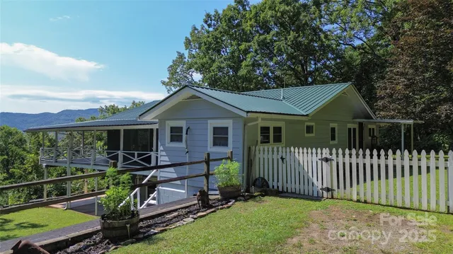 a view of a house with wooden fence