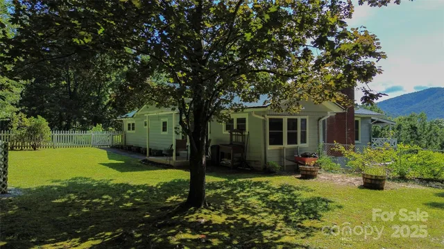 a view of a backyard with table and chairs and potted plants
