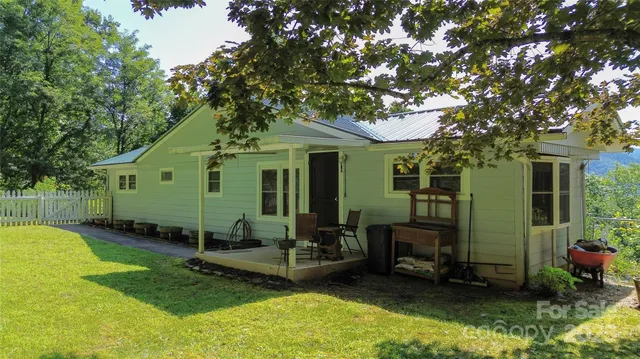 a view of a house with backyard porch and sitting area