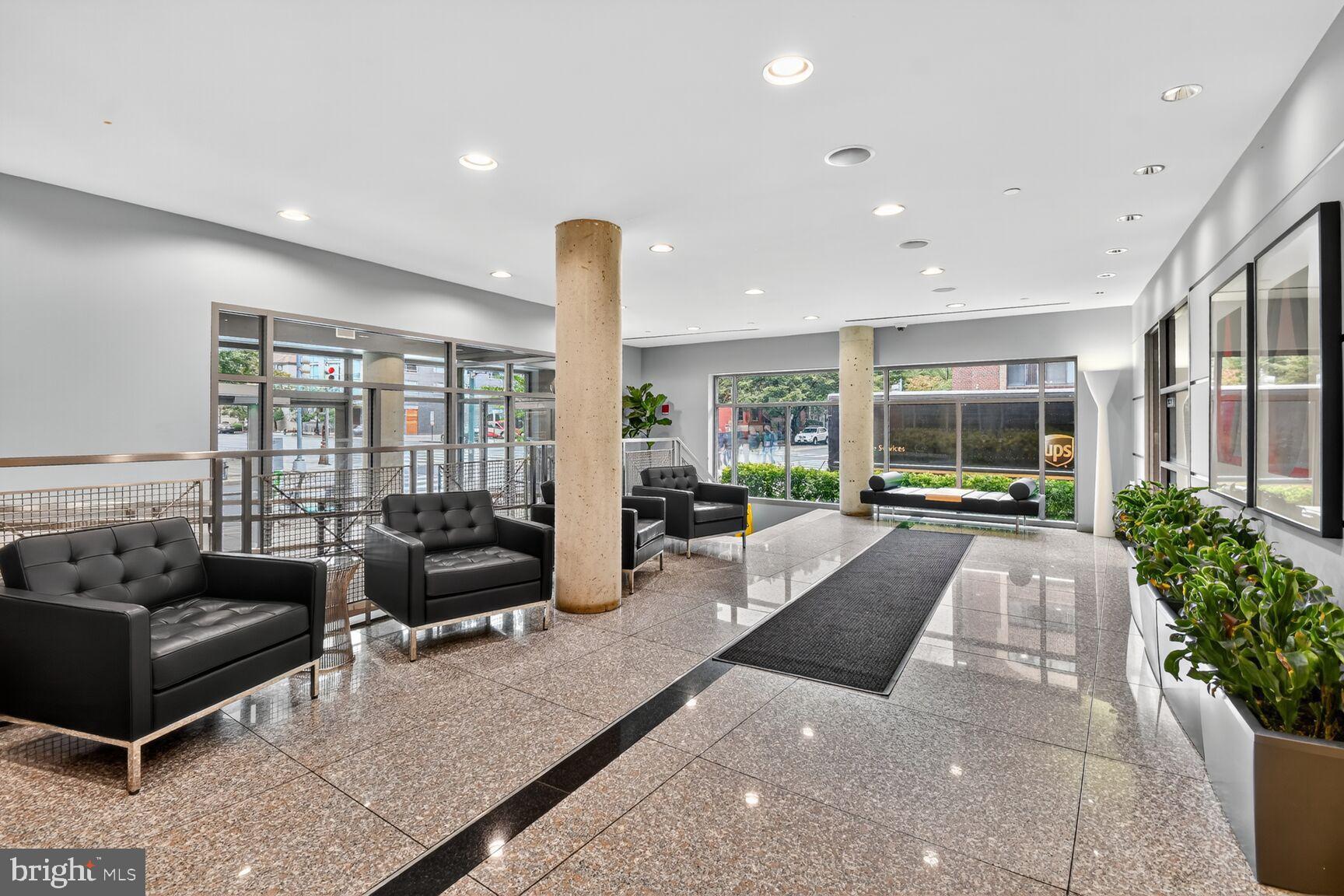 1300 N Street Northwest, Unit 214 Washington, DC 20005 - Photo 4 of 41 a lobby with furniture and floor to ceiling window