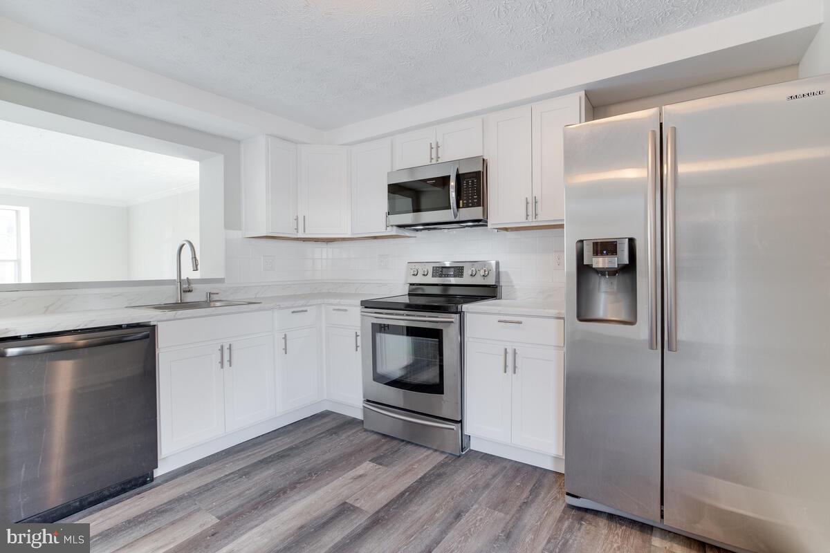1308 Apple Ridge Court Edgewood, MD 21040 - Photo 11 of 38 a kitchen with stainless steel appliances granite countertop a refrigerator stove and sink