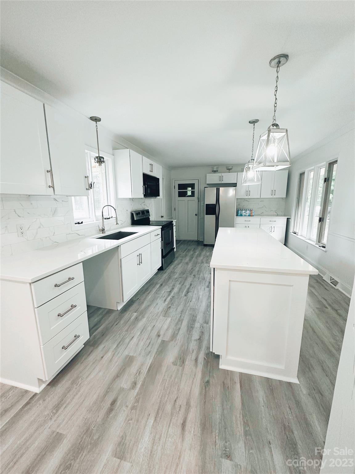 131 Mozelle Road Cherryville, NC 28021 - Photo 14 of 23 a kitchen with a sink stove and cabinets