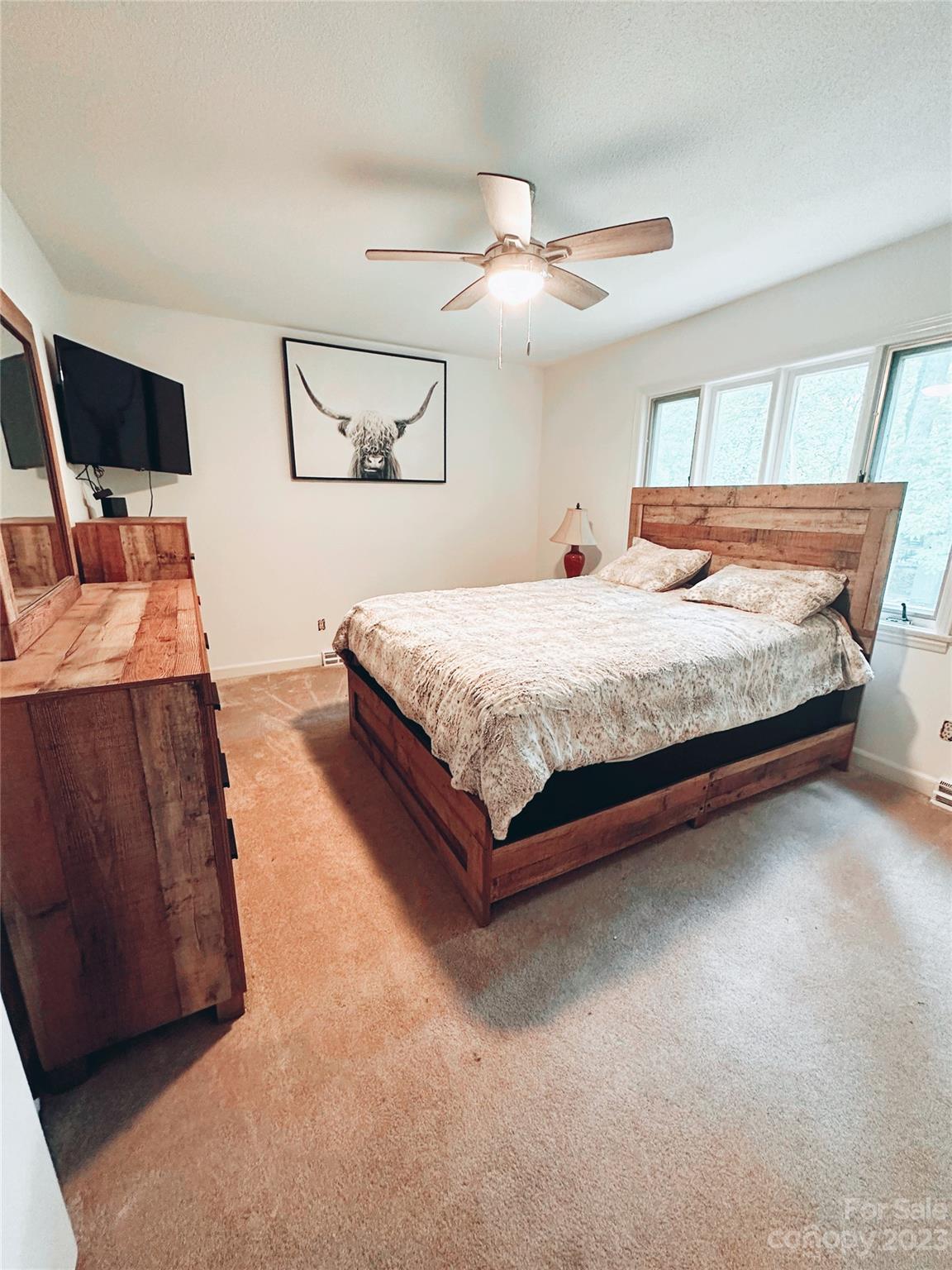 131 Mozelle Road Cherryville, NC 28021 - Photo 9 of 23 a spacious bedroom with a bed and lamp