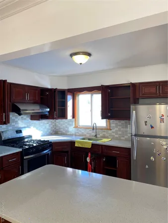 a kitchen with granite countertop a sink and cabinets