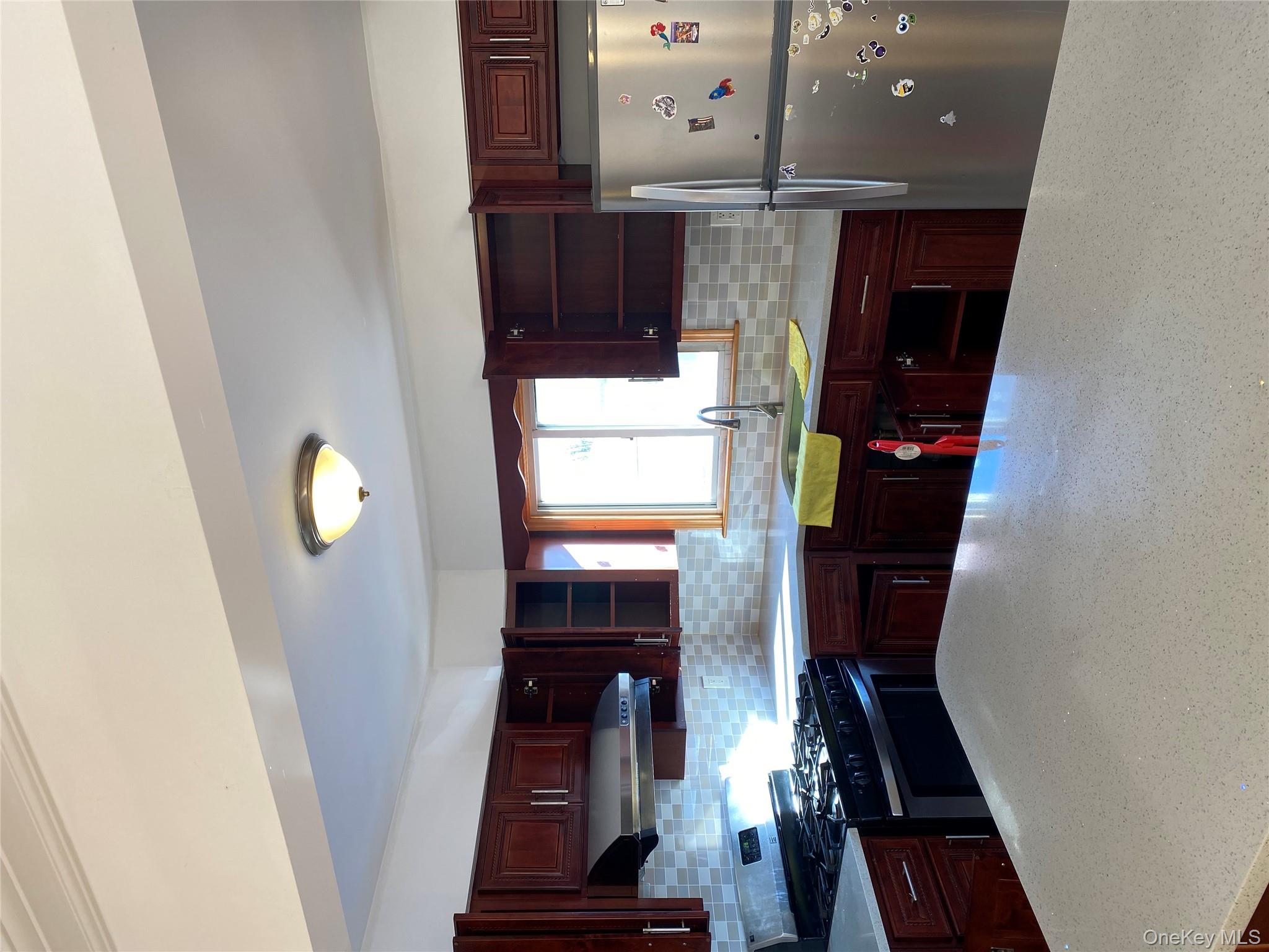 145-41 Willets Point Boulevard Queens, NY 11357 - Photo 3 of 8 a kitchen with granite countertop a sink and cabinets