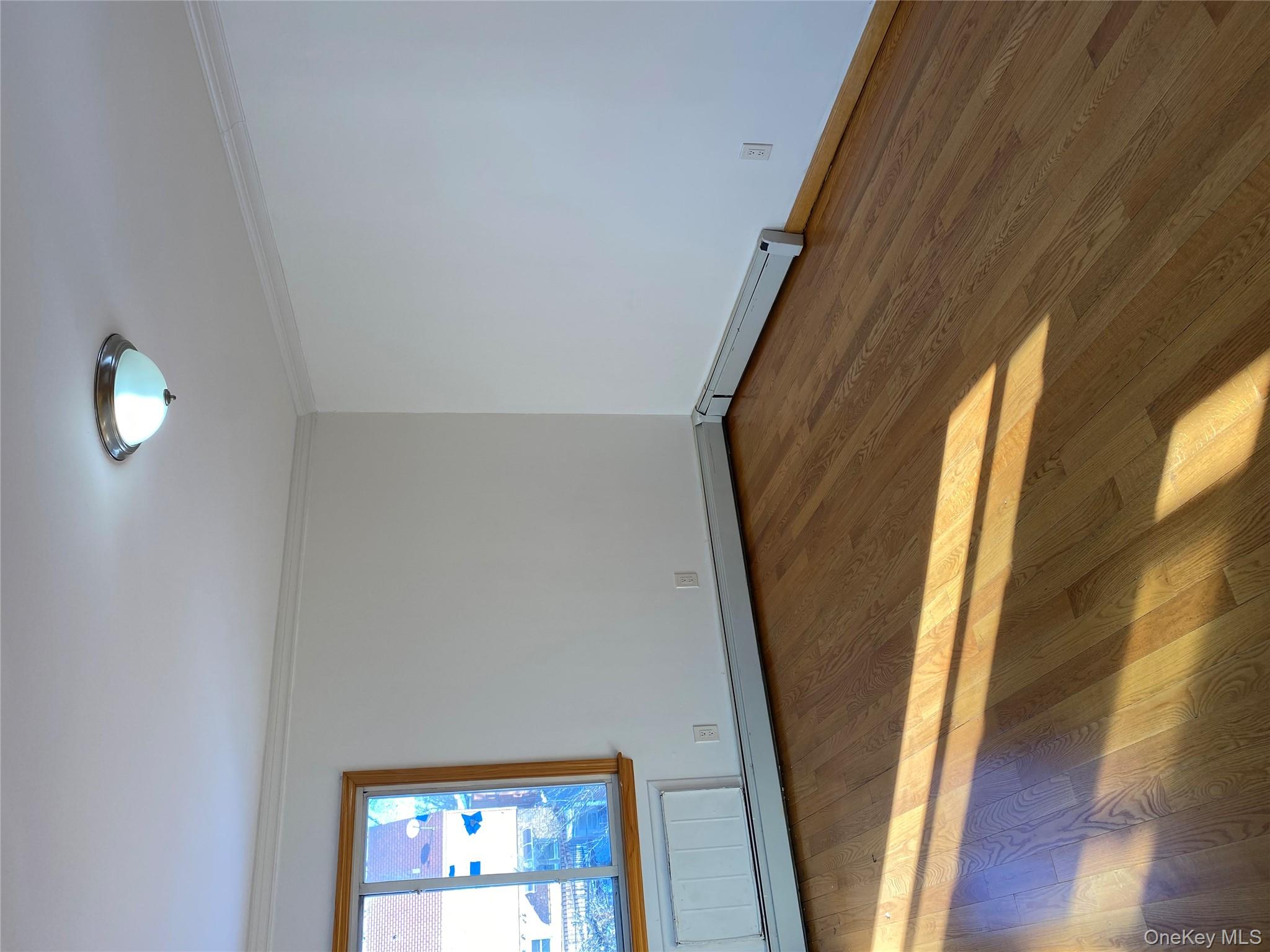 145-41 Willets Point Boulevard Queens, NY 11357 - Photo 4 of 8 a view of a room with wooden floor and window