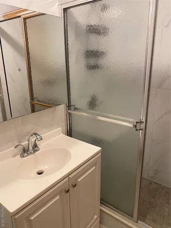 a bathroom with a sink and mirror