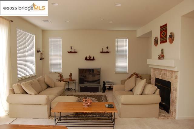 760 Waterville Drive Brentwood, CA 94513 - Photo 3 of 10 a living room with furniture a fireplace and a large window