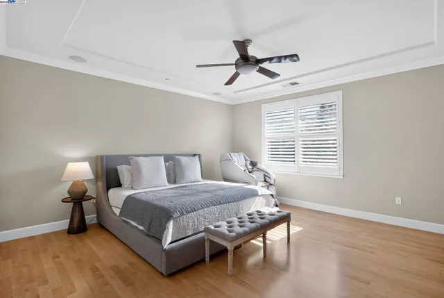 a bedroom with a bed and a chandelier