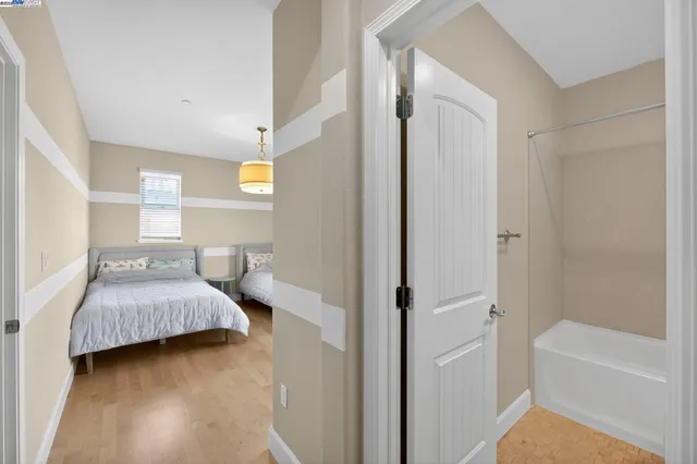 a bedroom with two beds and a window