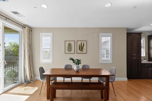 a dining room with furniture and wooden floor