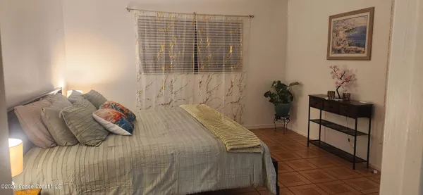 a view of a hallway to room with wooden floor