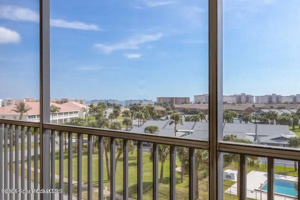 a room with furniture pool table and windows