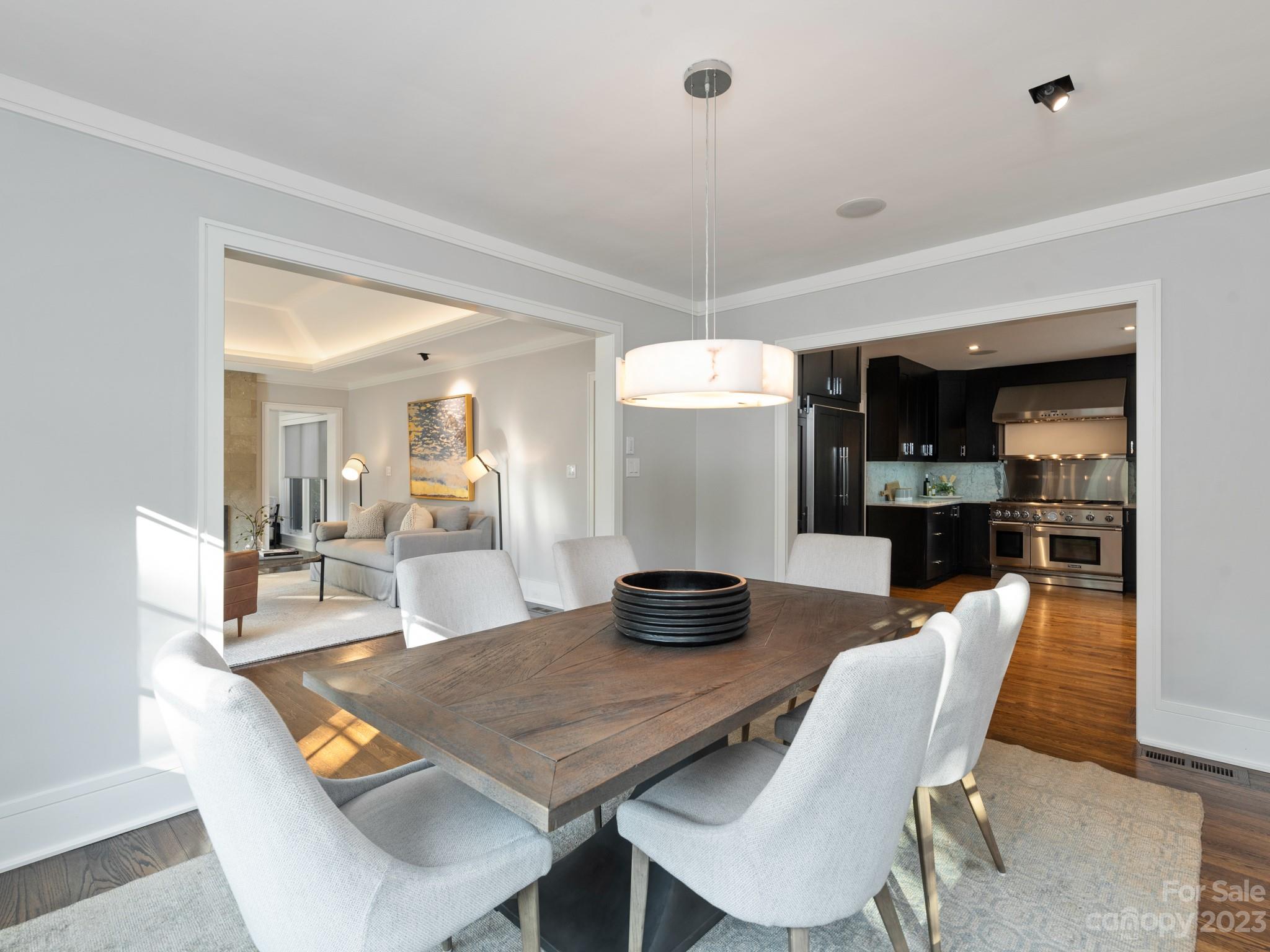 2743 Normandy Road Charlotte, NC 28209 - Photo 12 of 43 a dining room with furniture and wooden floor