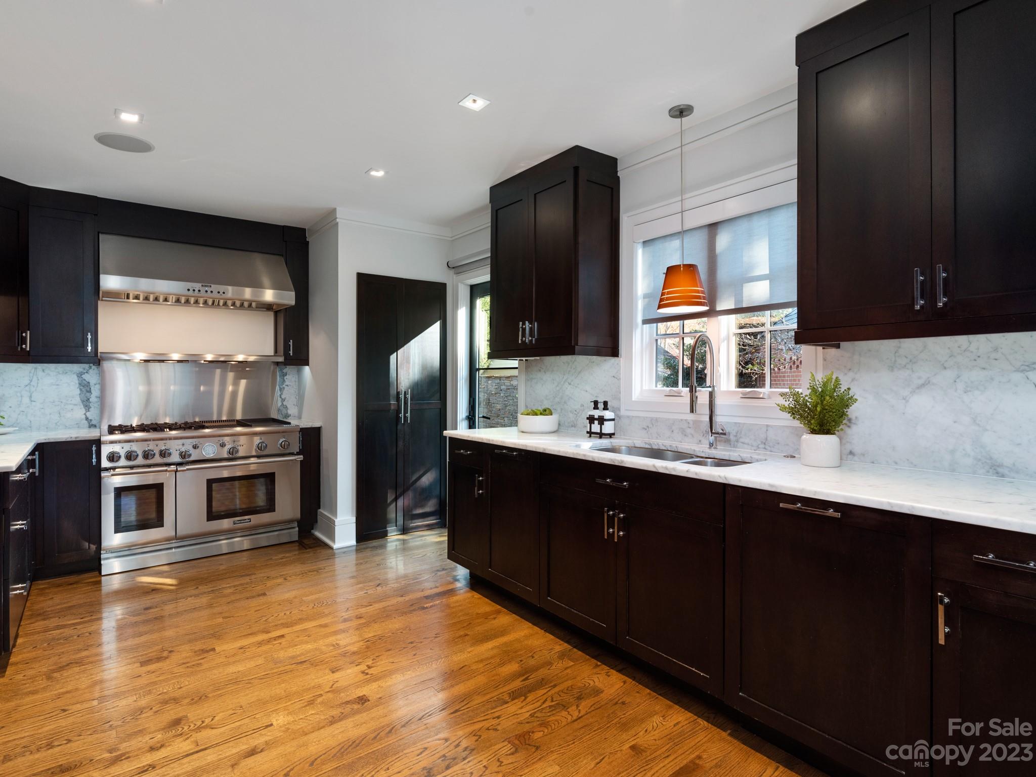 2743 Normandy Road Charlotte, NC 28209 - Photo 13 of 43 a kitchen with stainless steel appliances kitchen island granite countertop a refrigerator and a sink
