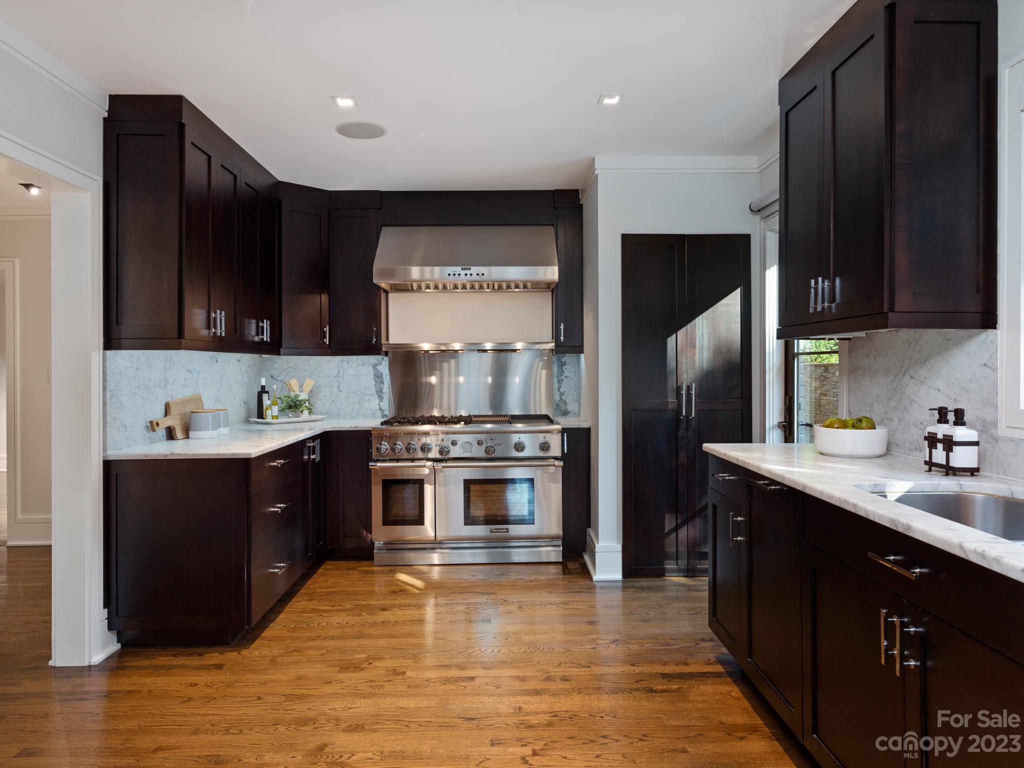2743 Normandy Road Charlotte, NC 28209 - Photo 14 of 43 a kitchen with stainless steel appliances granite countertop a refrigerator a sink a stove and wooden cabinets