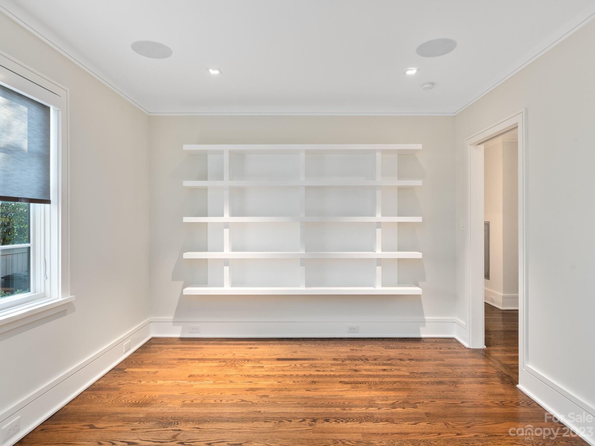 2743 Normandy Road Charlotte, NC 28209 - Photo 21 of 43 a view of an empty room with a window and wooden floor