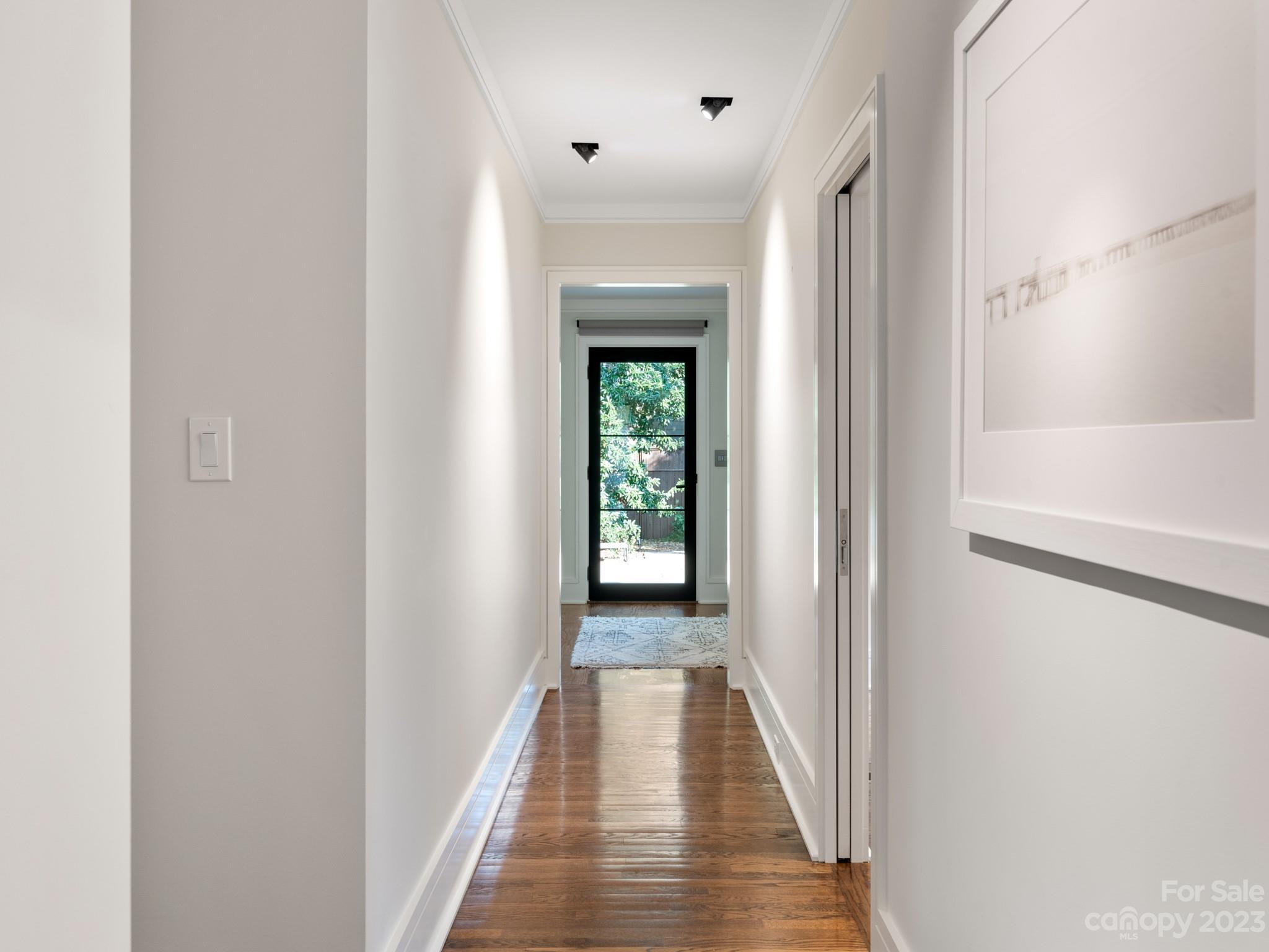 2743 Normandy Road Charlotte, NC 28209 - Photo 22 of 43 a view of a hallway with wooden floor and a window