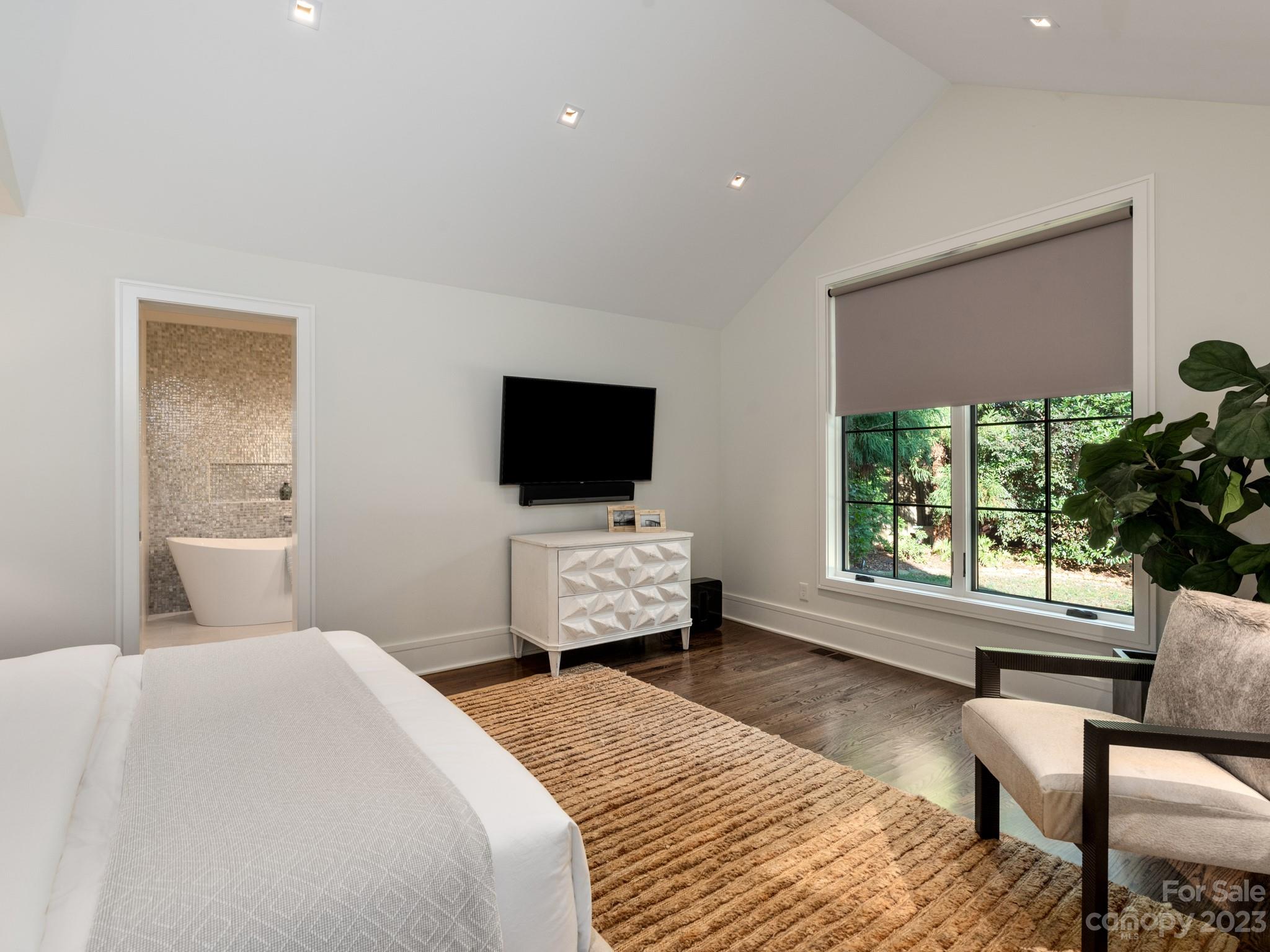 2743 Normandy Road Charlotte, NC 28209 - Photo 25 of 43 a bedroom with a bed and a flat screen tv