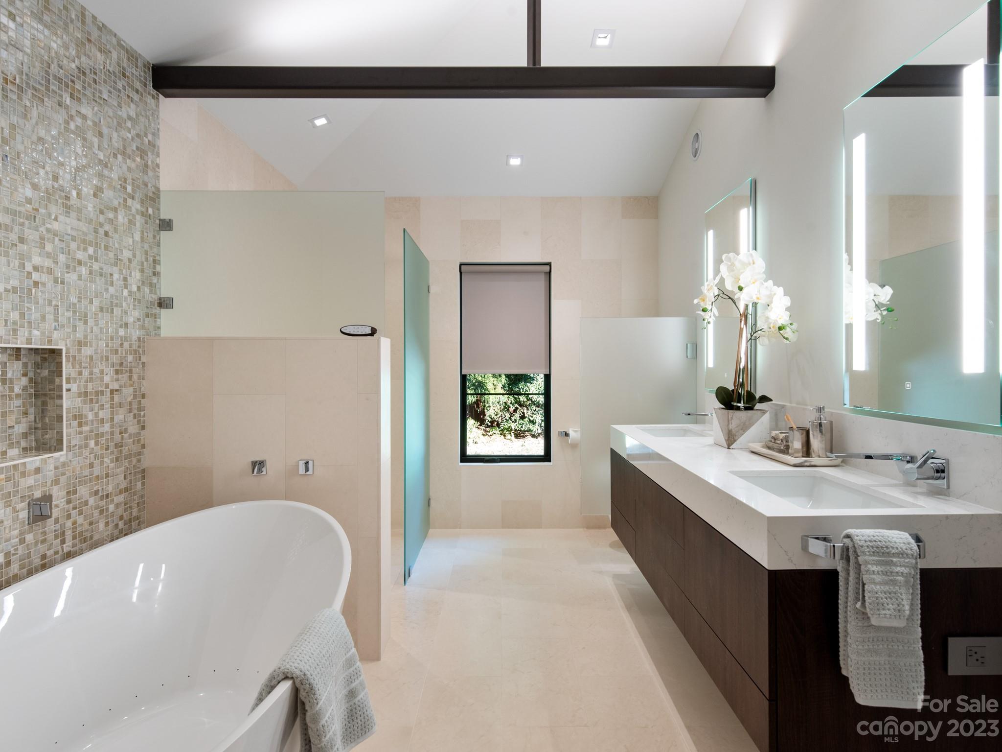 2743 Normandy Road Charlotte, NC 28209 - Photo 26 of 43 a spacious bathroom with a tub sink and mirror