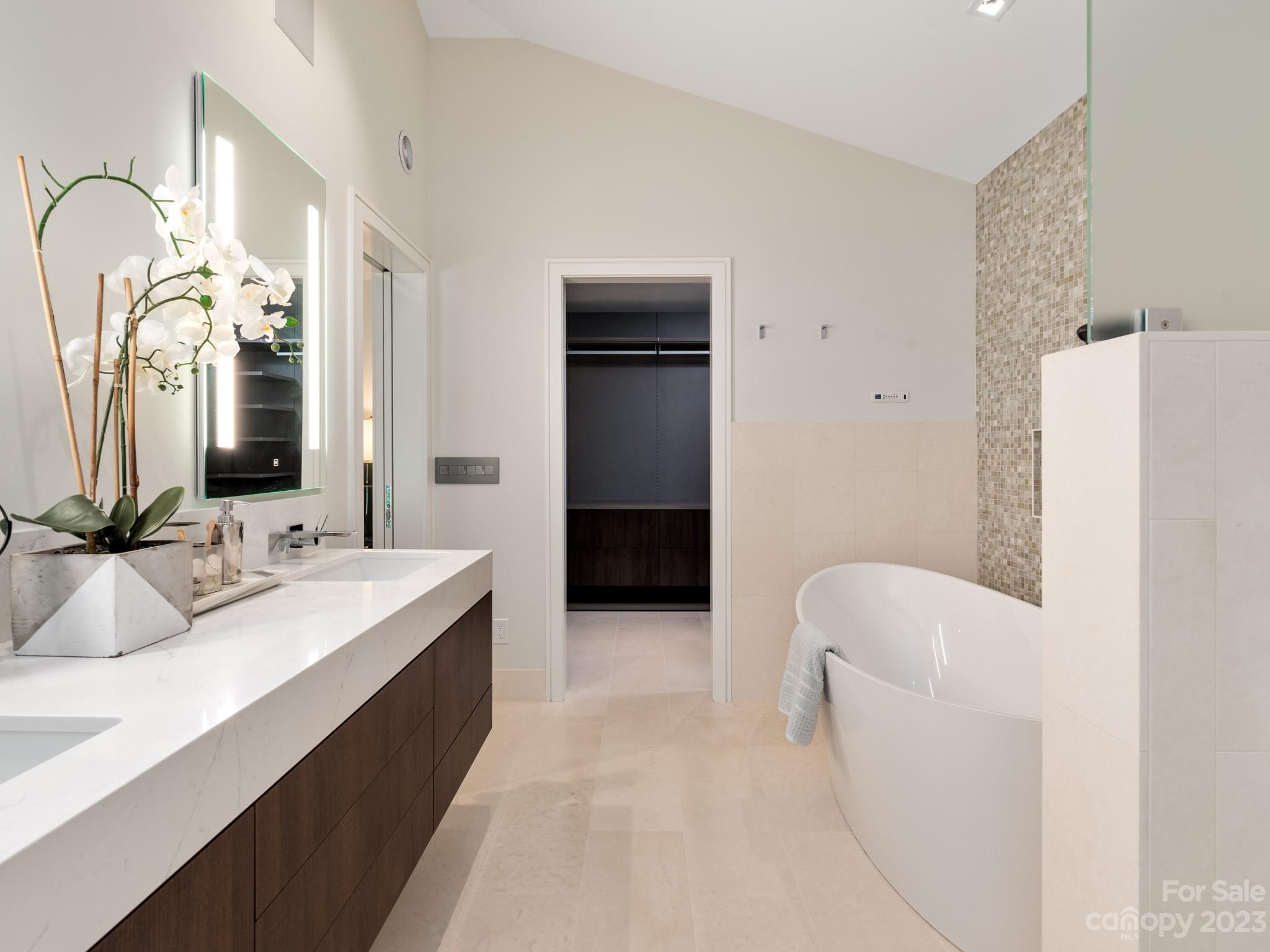 2743 Normandy Road Charlotte, NC 28209 - Photo 28 of 43 a en suite bathroom with a double vanity sink and a mirror