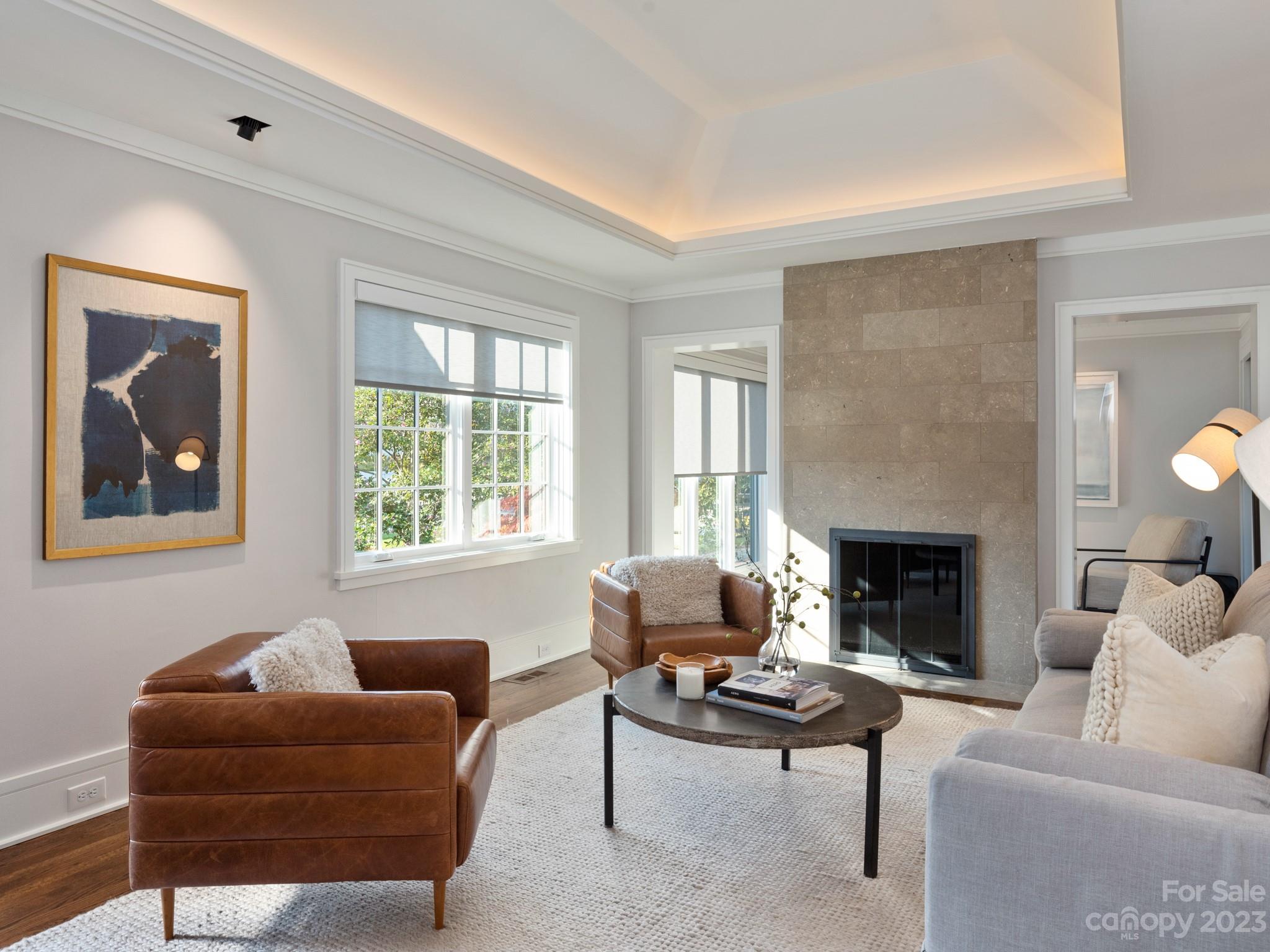 2743 Normandy Road Charlotte, NC 28209 - Photo 8 of 43 a living room with furniture a lamp and a fireplace