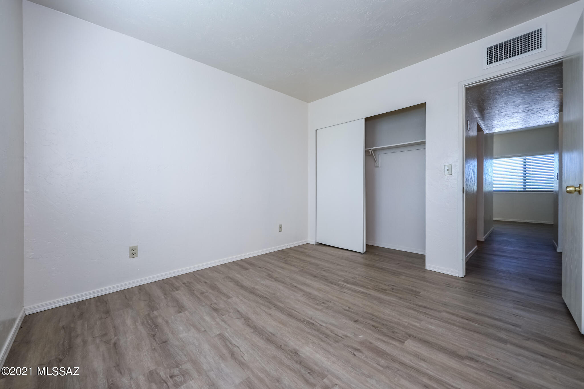 312 East 24th Street, Unit 4 Tucson, AZ 85713 - Photo 10 of 17 a view of an empty room with wooden floor and closet