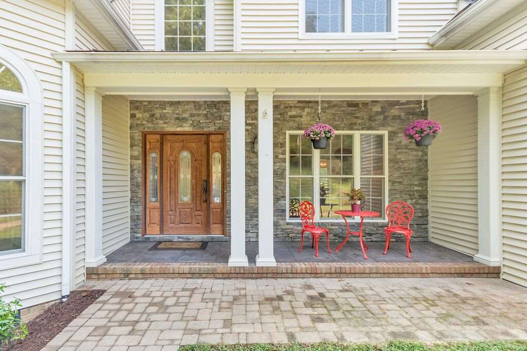 417 Buffalo Run Road Stanardsville, VA 22973 - Photo 3 of 36 a backyard of a house with outdoor seating
