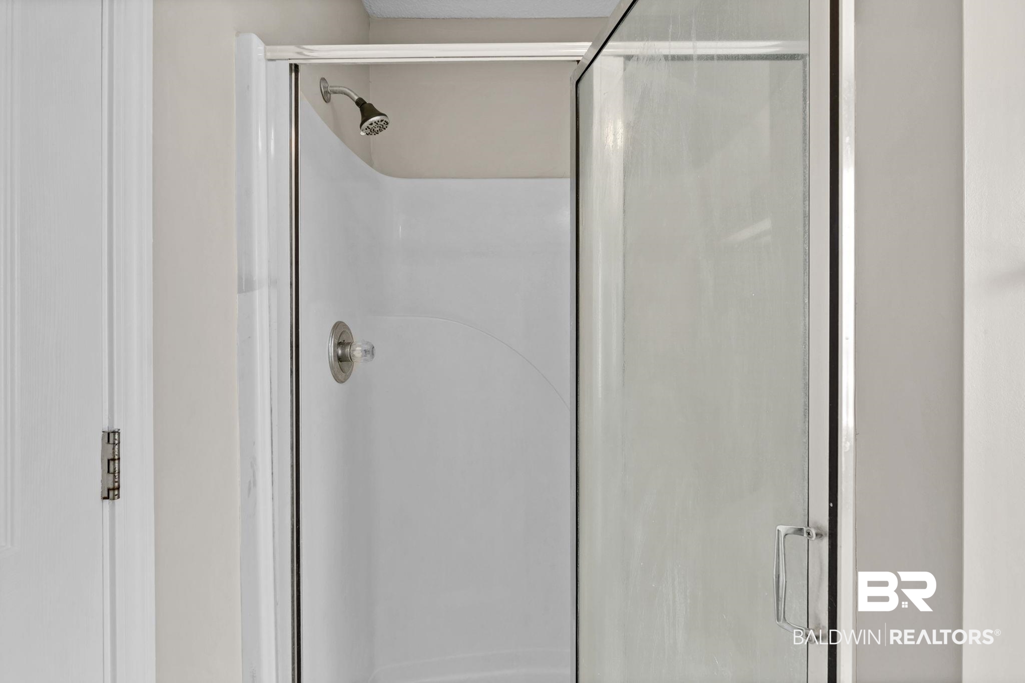 10238 Grove Drive Fairhope, AL 36532 - Photo 19 of 39 Bathroom with 2 closets, a garden tub, separate shower, private water closet, wood finished floors, and double vanity.