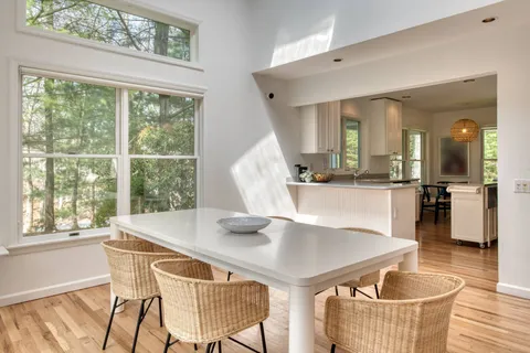 a dining room with furniture and wooden floor