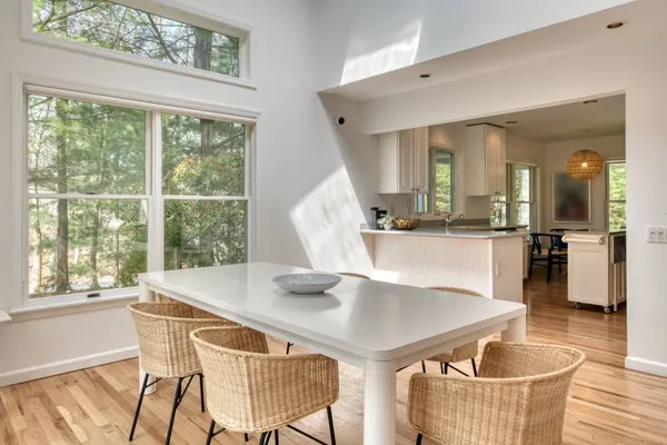 a dining room with furniture and wooden floor