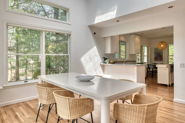 a dining room with furniture and wooden floor