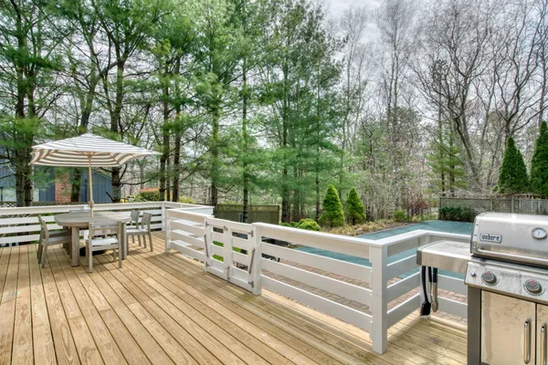 a view of backyard with seating area and trees