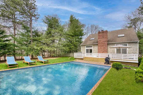 swimming pool with outdoor seating and yard