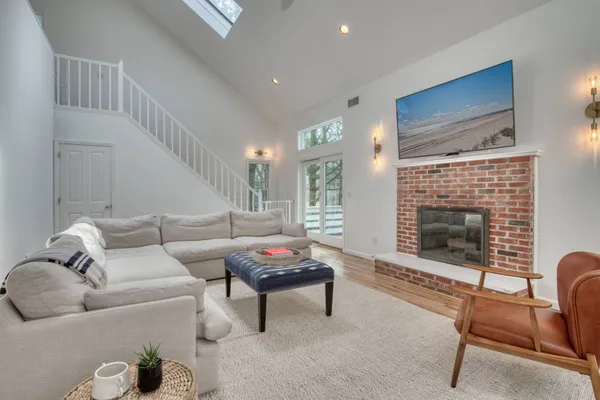 a living room with furniture a rug and a fireplace