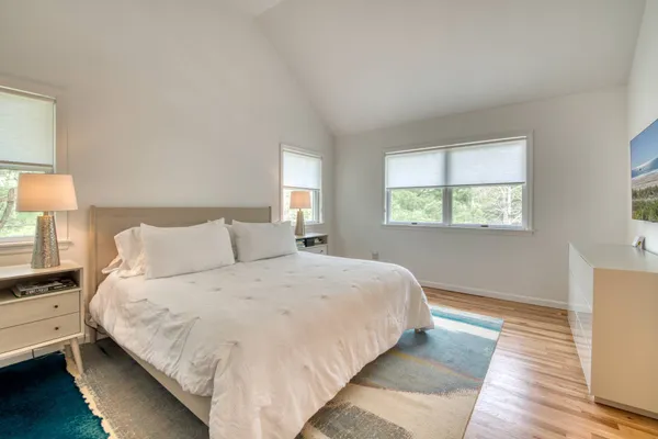 a bedroom with a bed and a night stand