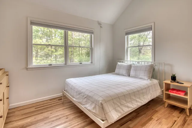 a bedroom with a bed and a window