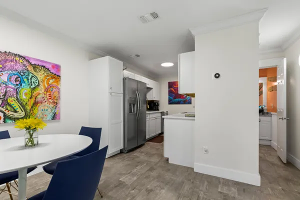 a kitchen with stainless steel appliances kitchen island granite countertop a sink and a stove top oven with wooden floor