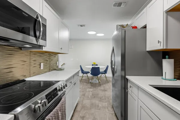 a kitchen with a stove and a sink