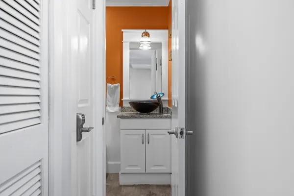a bathroom with a granite countertop sink and a mirror