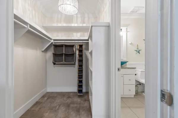 a spacious bathroom with a granite countertop sink a mirror a toilet and a shower