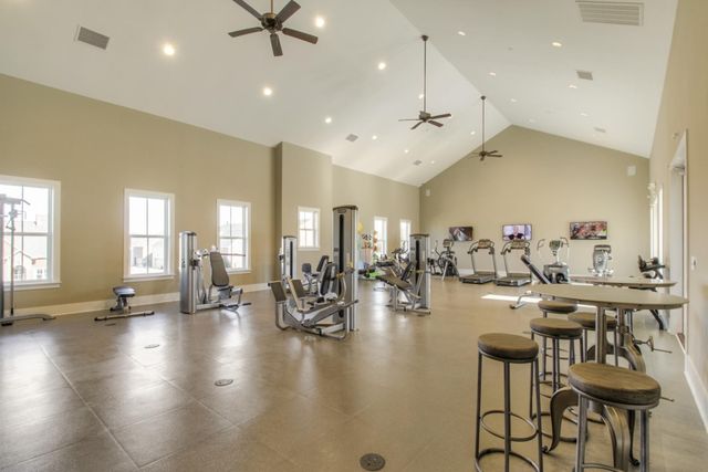 a view of a swimming pool with a chairs and plants