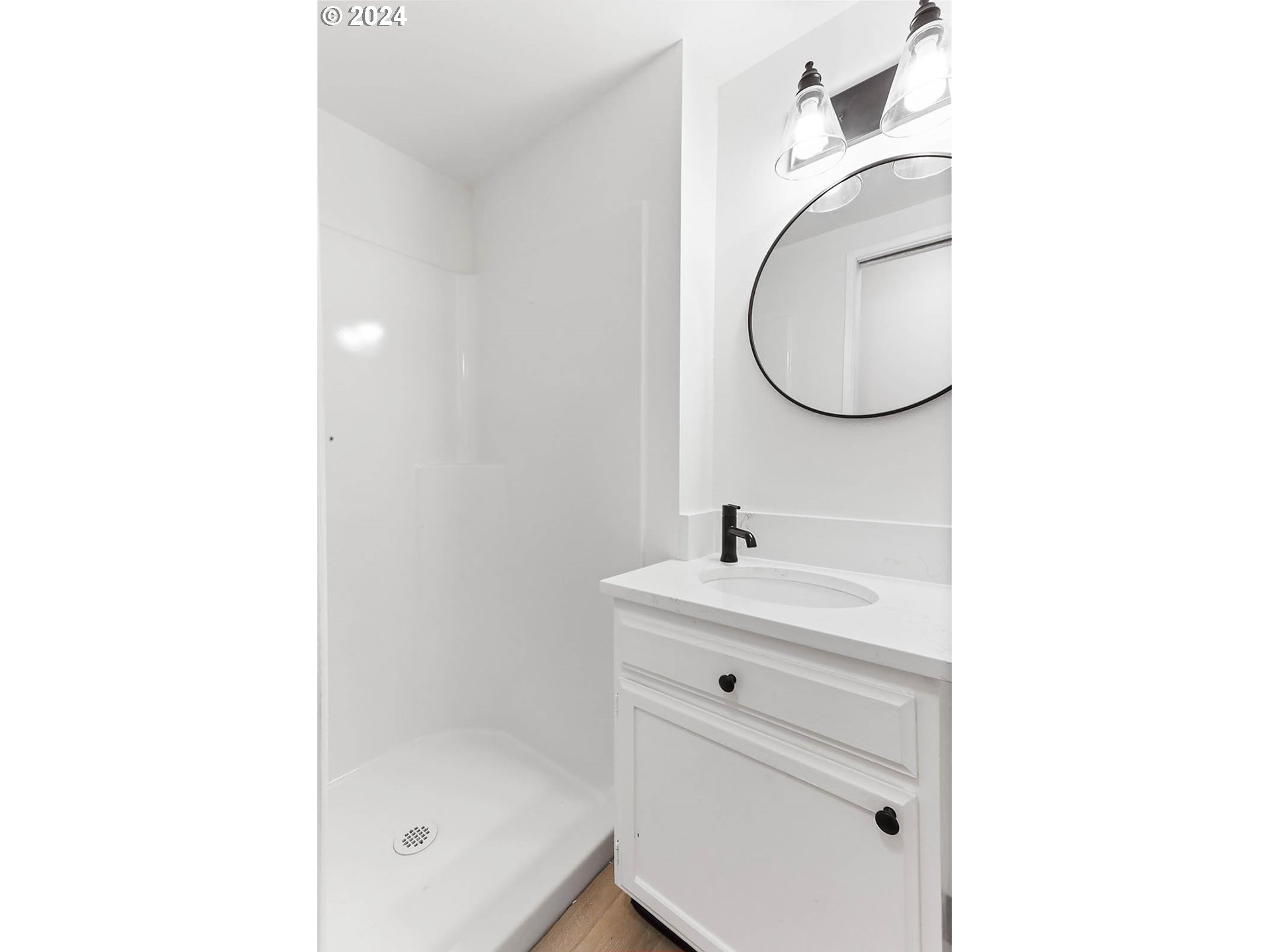 1710 B Street Hood River, OR 97031 - Photo 14 of 42 a bathroom with a sink a mirror and a shower