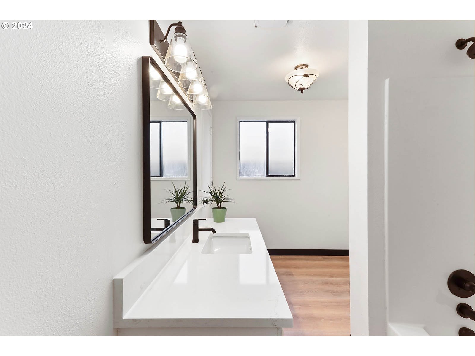 1710 B Street Hood River, OR 97031 - Photo 17 of 42 a en suite bathroom with a sink a mirror and a bathtub