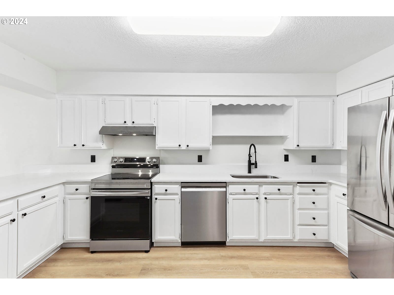 1710 B Street Hood River, OR 97031 - Photo 32 of 42 a kitchen with stainless steel appliances a stove a sink and a refrigerator