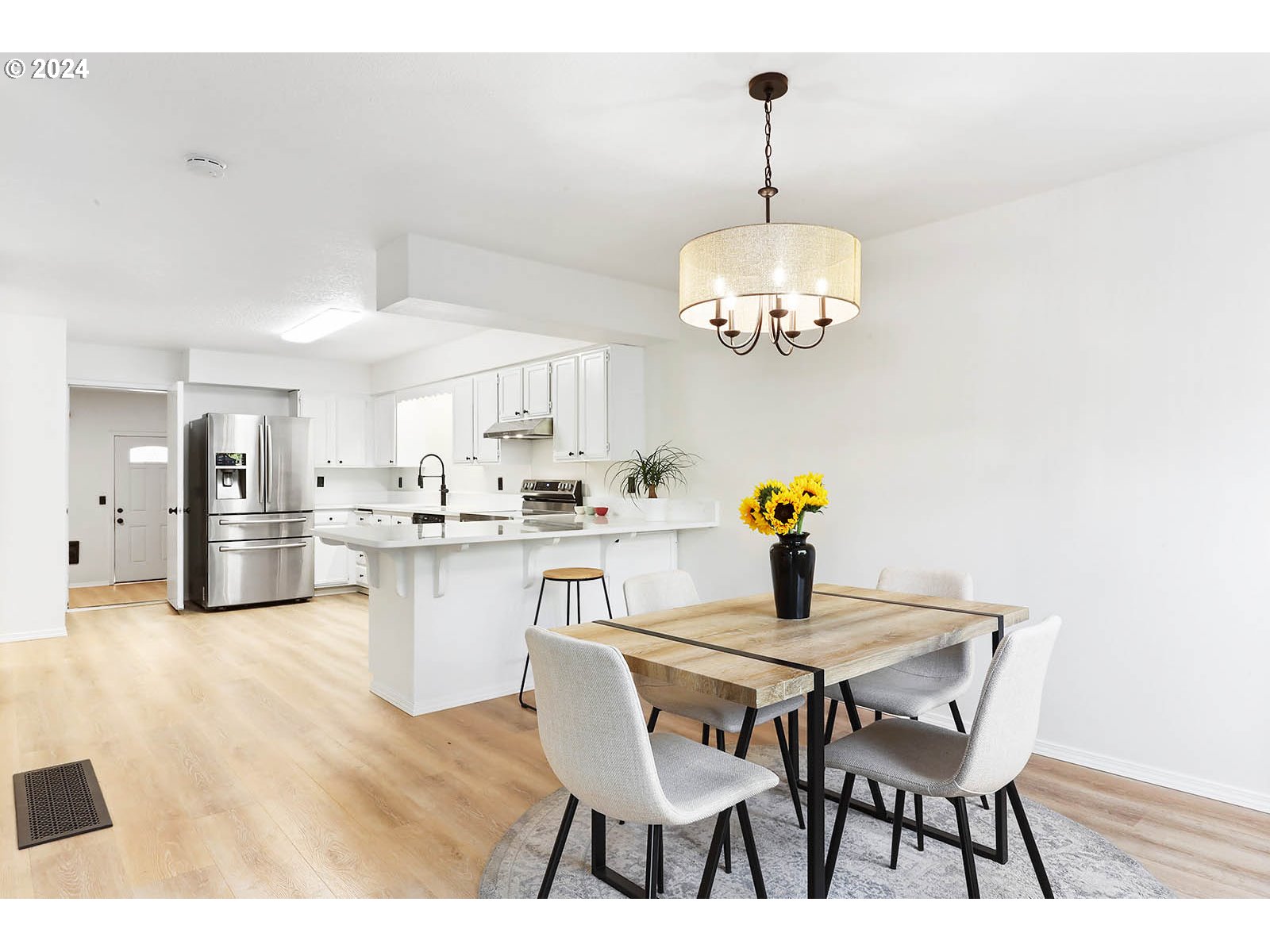 1710 B Street Hood River, OR 97031 - Photo 8 of 42 a view of a dining room with furniture a chandelier and wooden floor