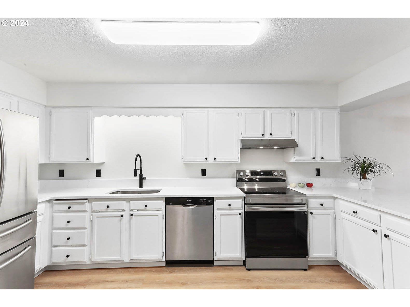 1710 B Street Hood River, OR 97031 - Photo 10 of 42 a kitchen with a white stove top oven sink and cabinets