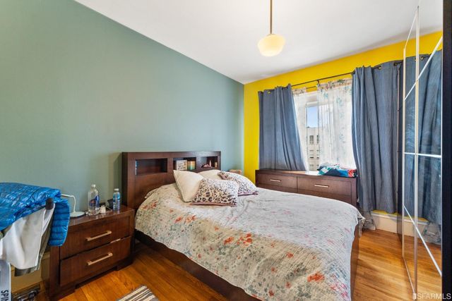 a bedroom with a bed and a dresser