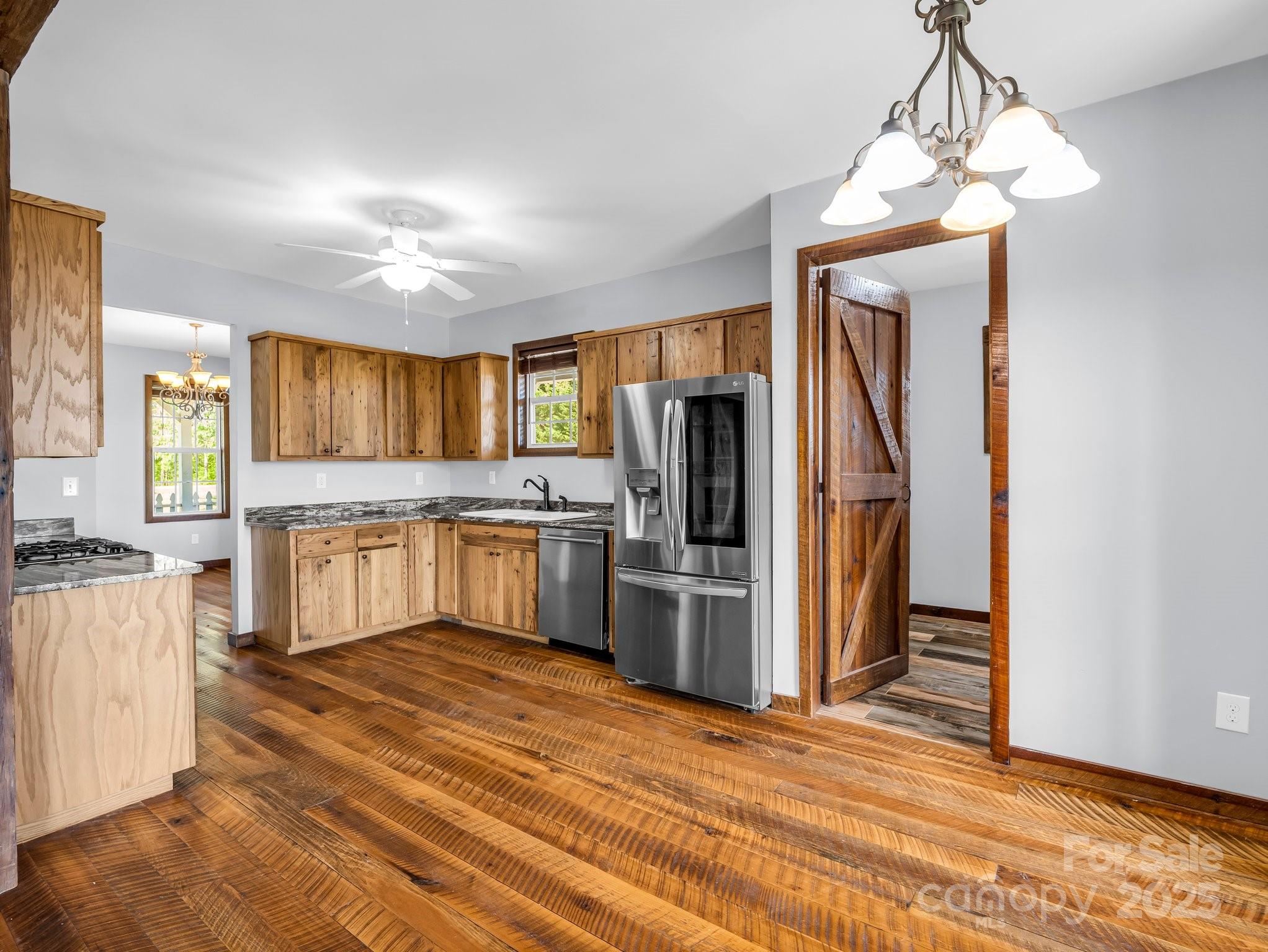 4830 Chesnee Road Rutherfordton, NC 28139 - Photo 24 of 45 a kitchen with white cabinets and stainless steel appliances