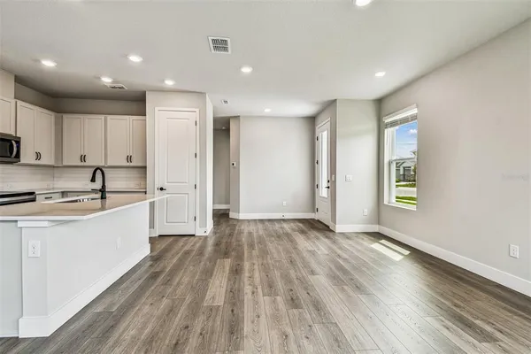a view of a room with wooden floor and floor to ceiling window